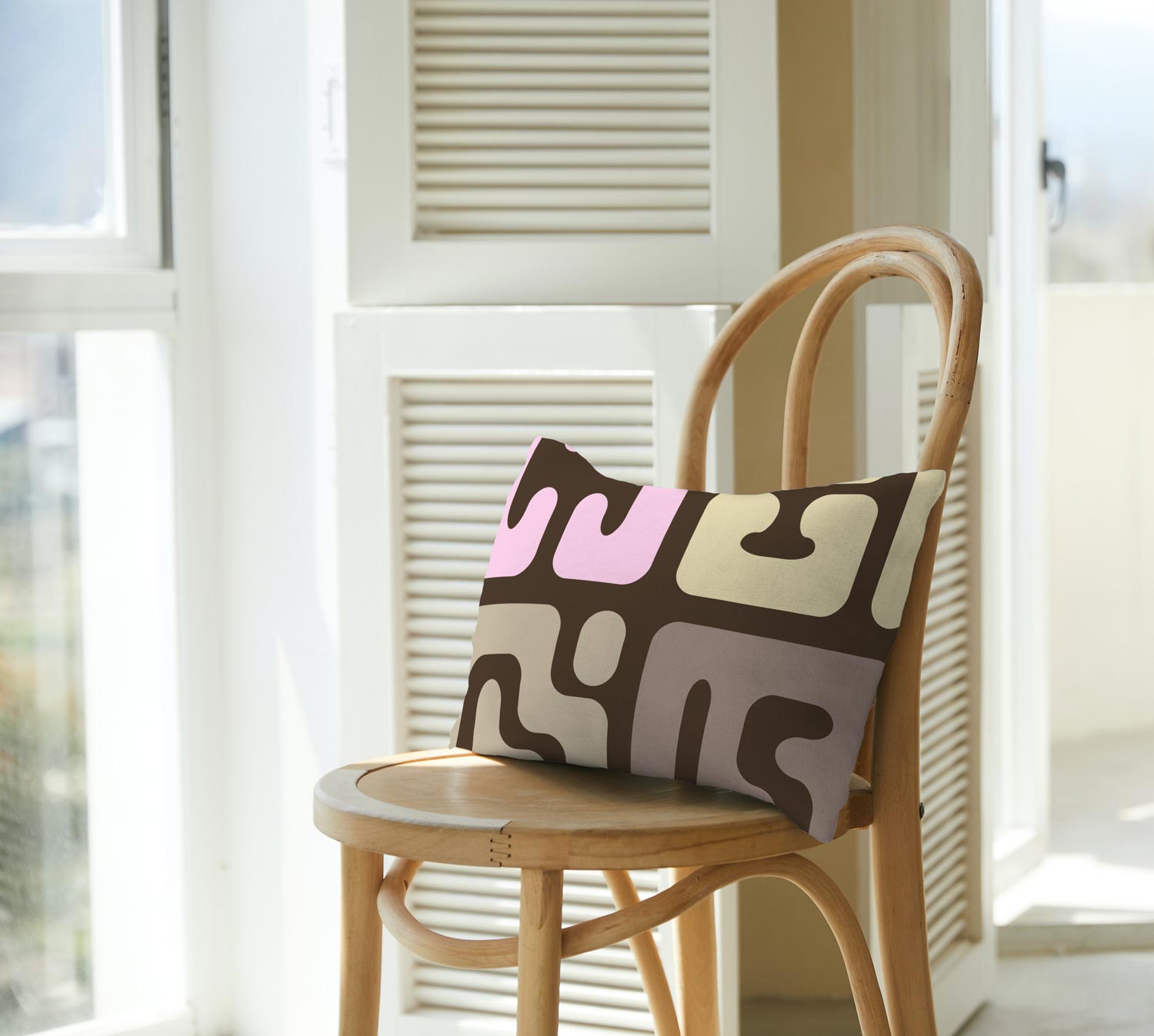 Modern Kuba cloth inspired lumbar pillow with pop of pink